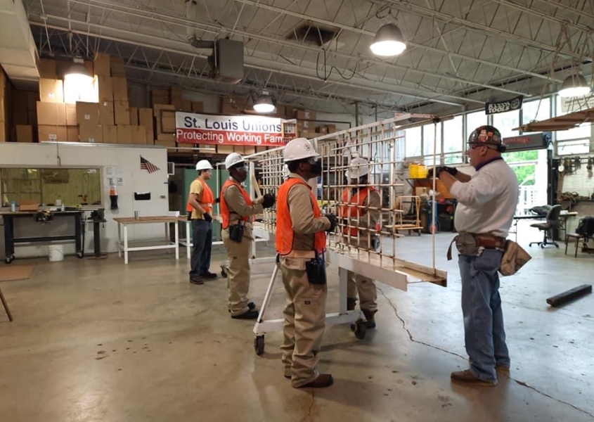 Building Union Diversity (BUD) workers carrying scaffolding