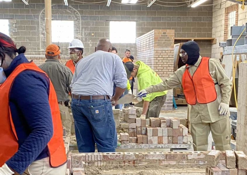 Building Union Diversity (BUD) workers building with bricks in a shop